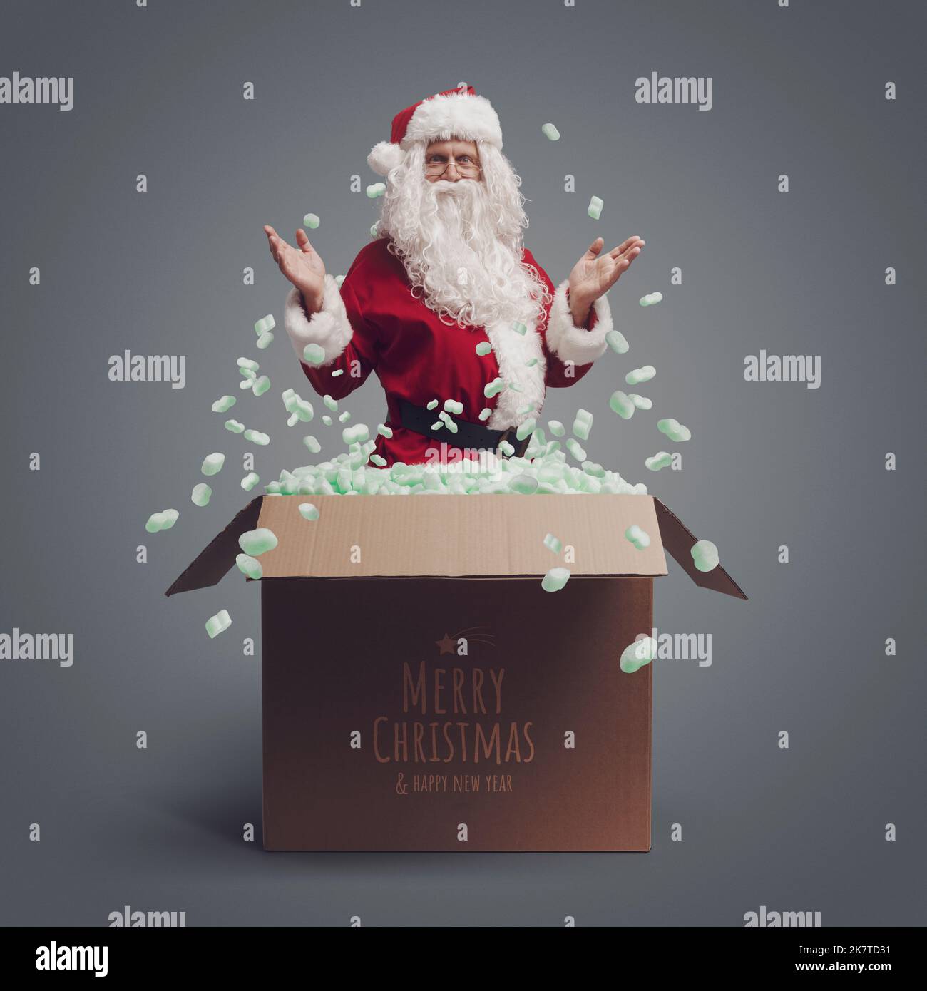 Happy Santa Claus coming out from a delivery box and Christmas wishes ...