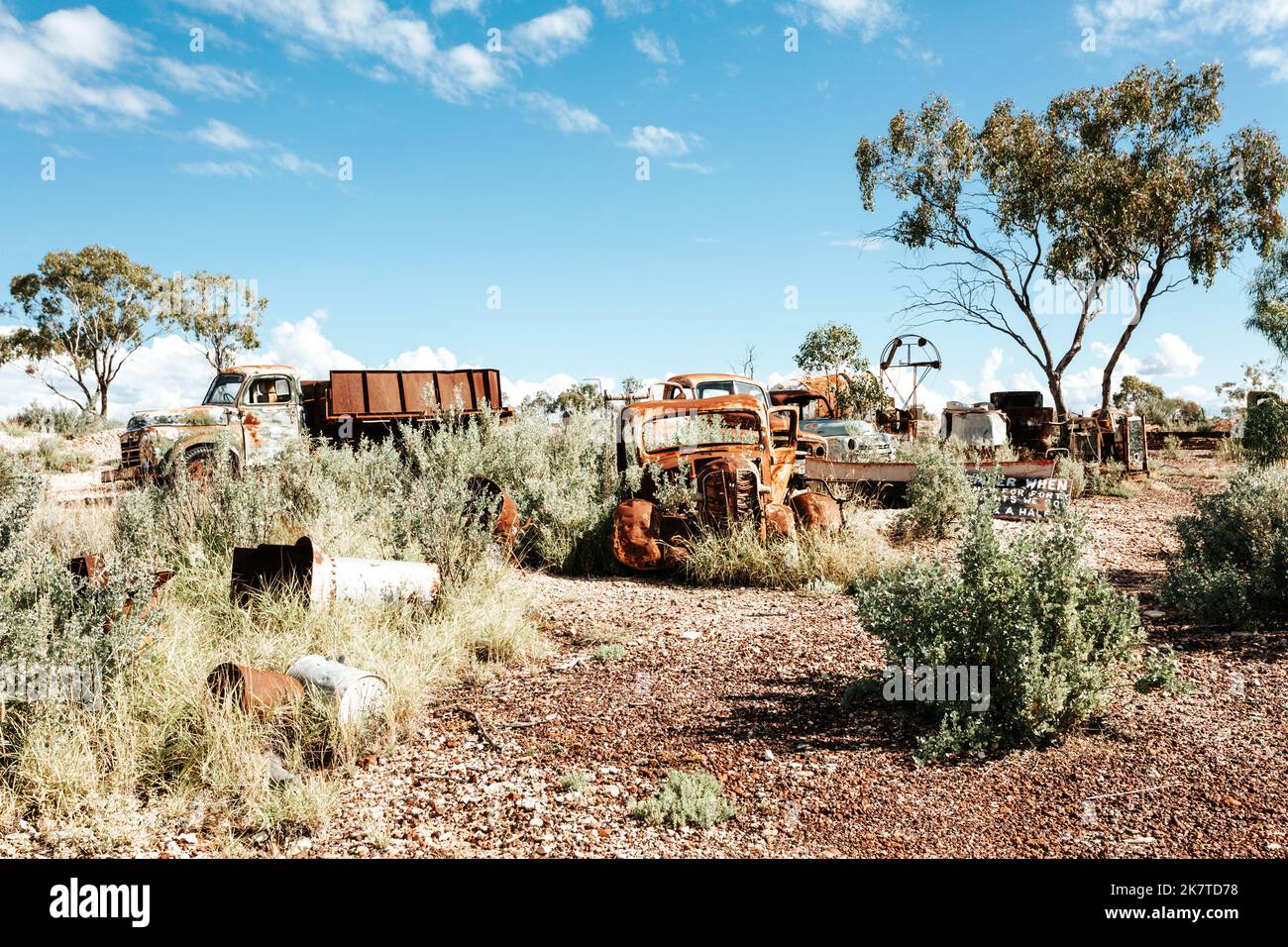 Rusty cars trucks and other items in the desert of outback Australia Stock Photo
