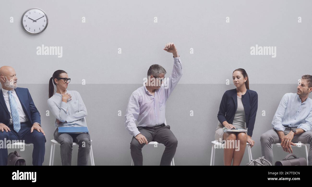 Anxious scared man sitting and waiting for a job interview, he is