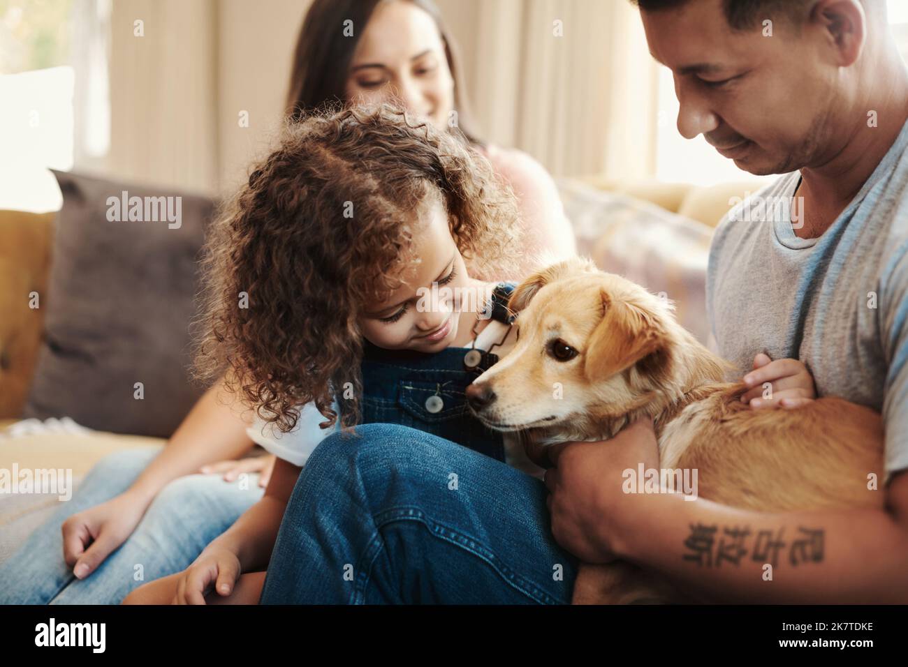 Teaching her responsibility while owning a pet. a young family sitting