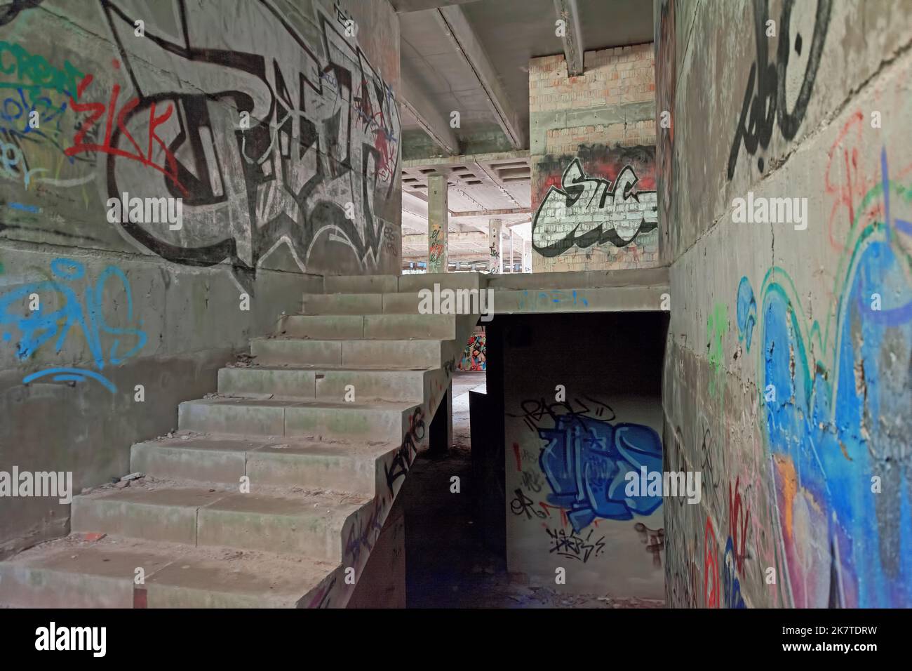 Staircase in abandoned ruin, walls sprayed with graffiti Stock Photo