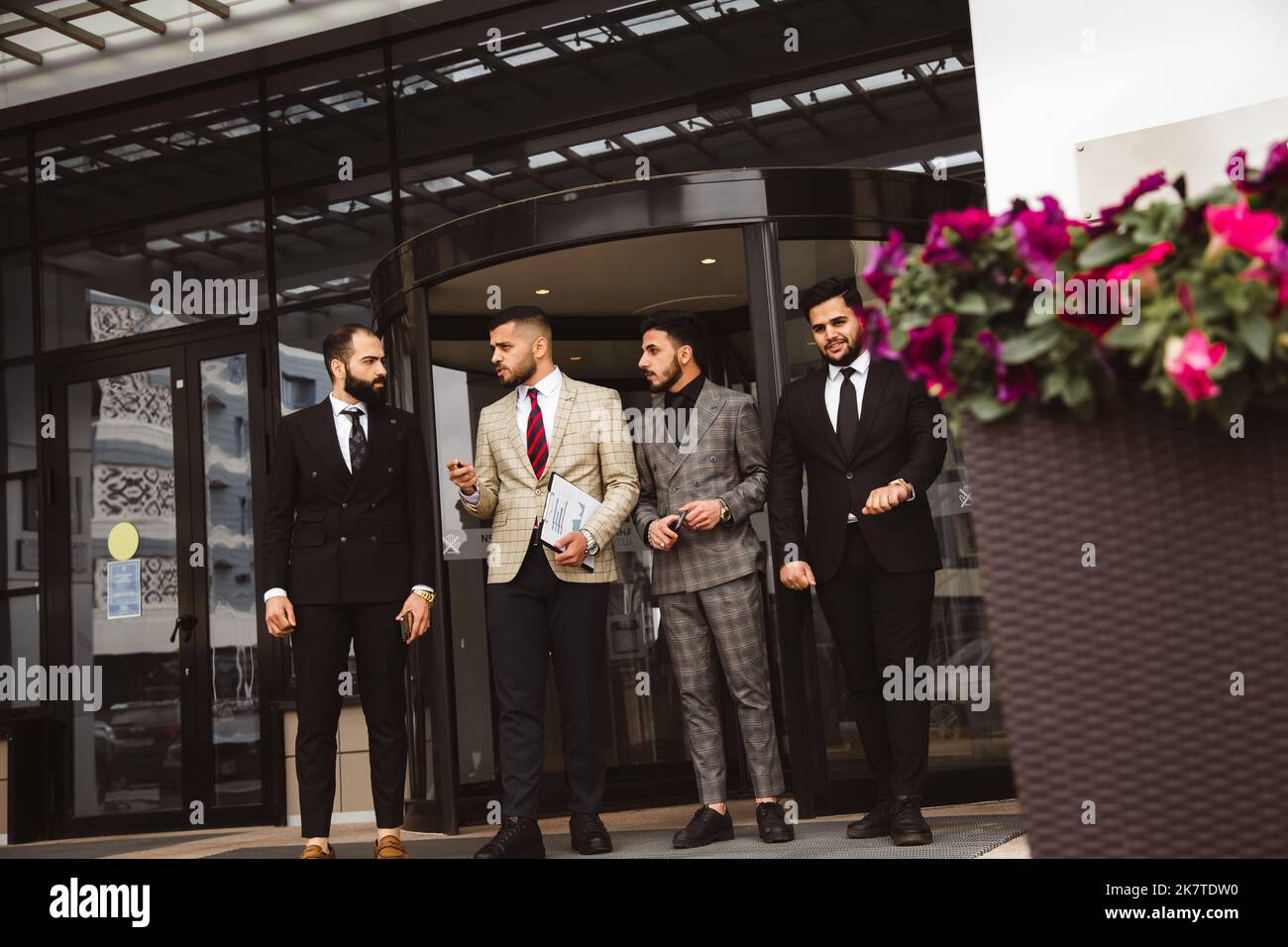 Business people outdoor meeting. A group of male businessmen in suits ...