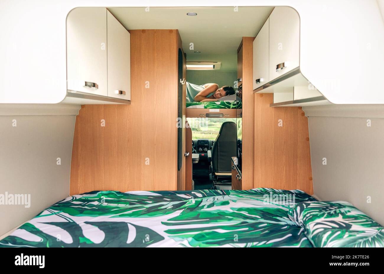 Woman sleeping alone on camper van bunk bed Stock Photo Alamy