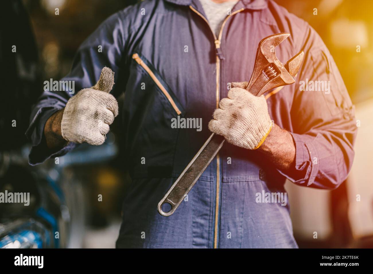 auto mechanic handle wrench with thumbs up confirm car service quality