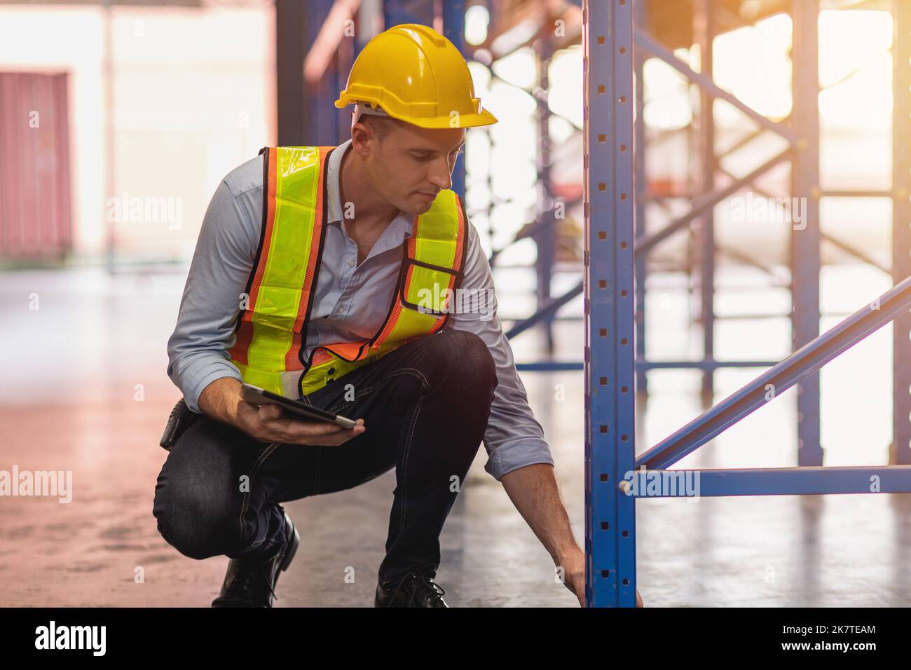 warehouse engineer builder check cargo metal rack shelf setup loading weight standard for safety industry Stock Photo