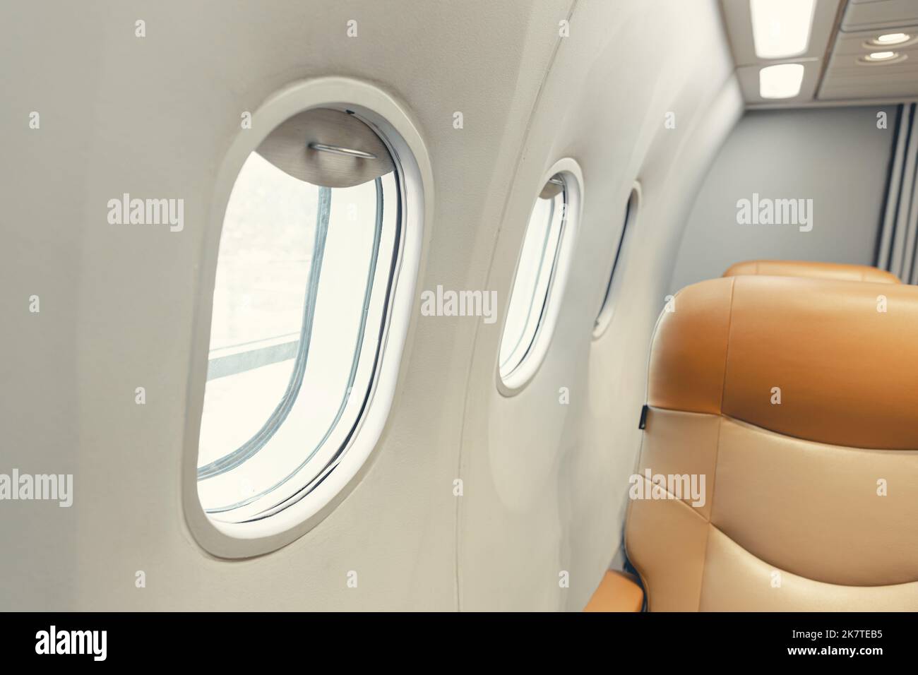 closeup aircraft passenger cabin interior windows seat row. aeroplane round safety glass window. Stock Photo