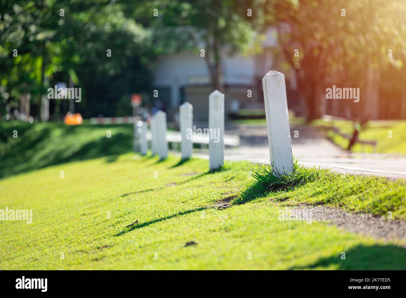 white milestone at country road side for target business step forward indicator concept Stock Photo