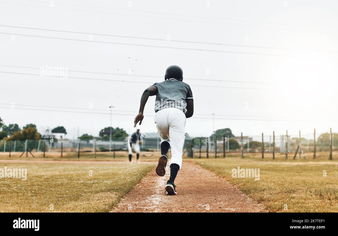 Baseball player, running and sports pitch with athlete with fast energy doing base run at game or match on a sport field. Fitness, exercise and Stock Photo