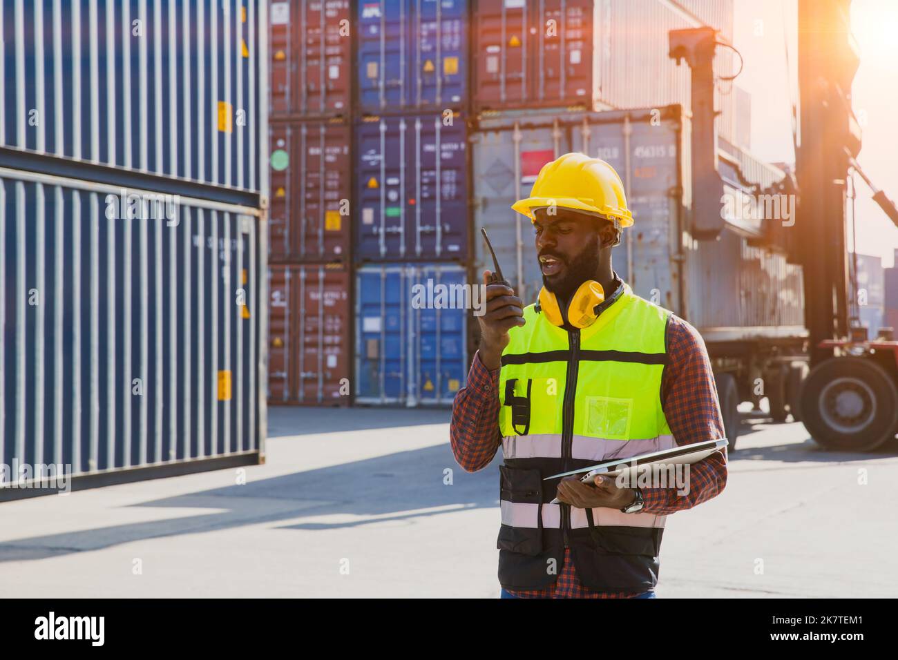 customs shipping staff worker working at cargo port container ship yard with radio control Stock Photo