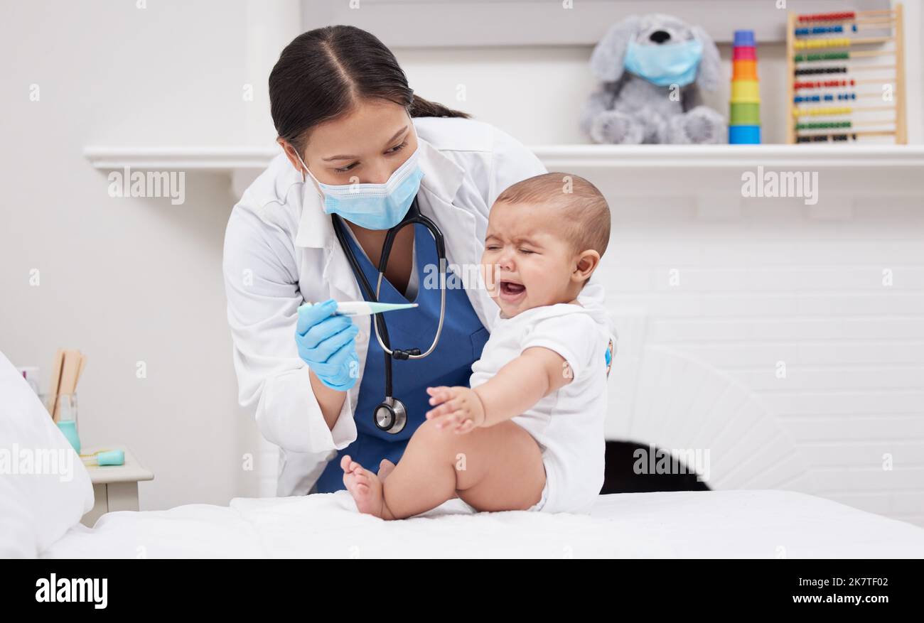 For me, this baby was the most precious thing I had ever had. a doctor giving medicine to a baby in a hospital. Stock Photo