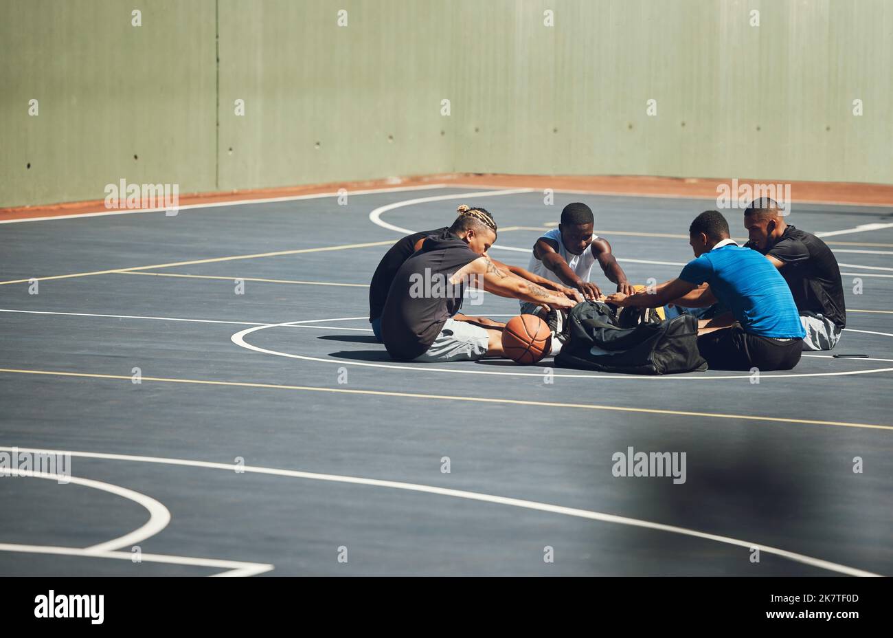 Basketball, team and stretching on sports court to warm up for training