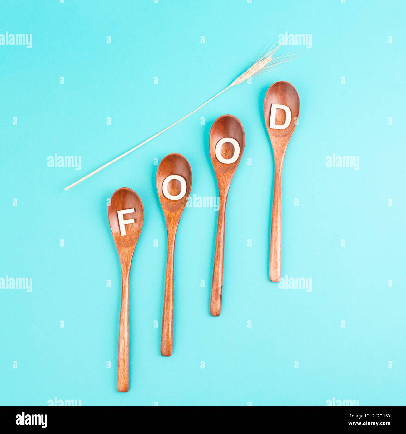 Wooden spoons with the word food and wheat ears, prices increase, crisis and shortages, supply chain problems Stock Photo