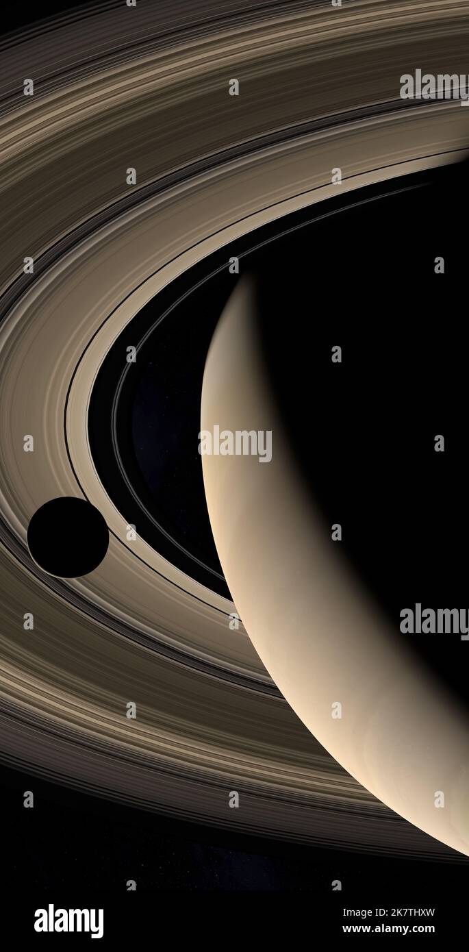 Moon or satellite orbiting around Saturn planet and her rings in the outer space Stock Photo