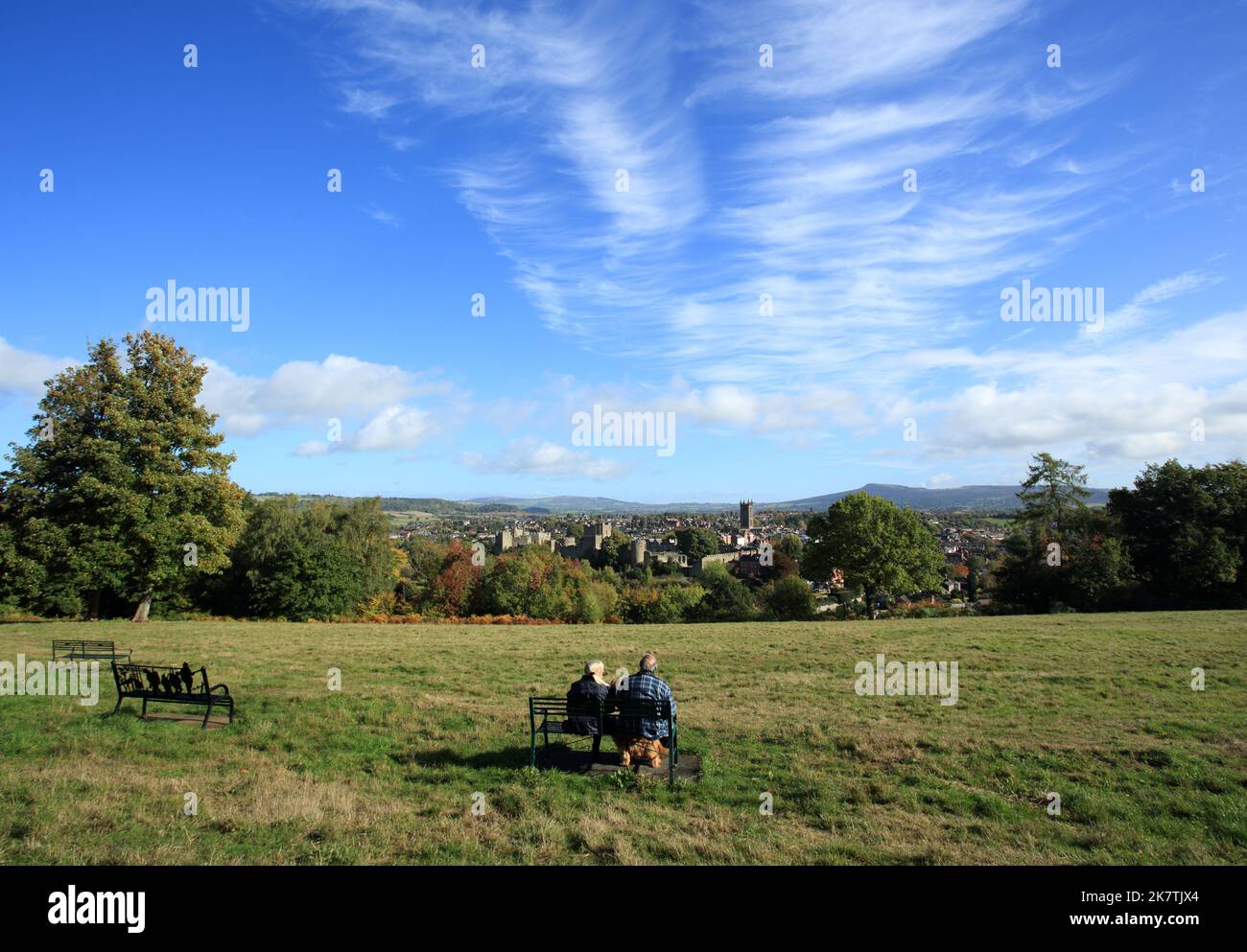 People enjoying the view of Ludlow town and castle from Whitcliffe common nature reserve, Shropshire, England, UK. Stock Photo