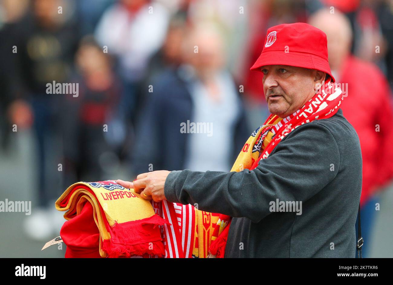 Street trader selling half and half football scarves outside of a premier league football Street trader selling half and half football scarves outside of a premier league football