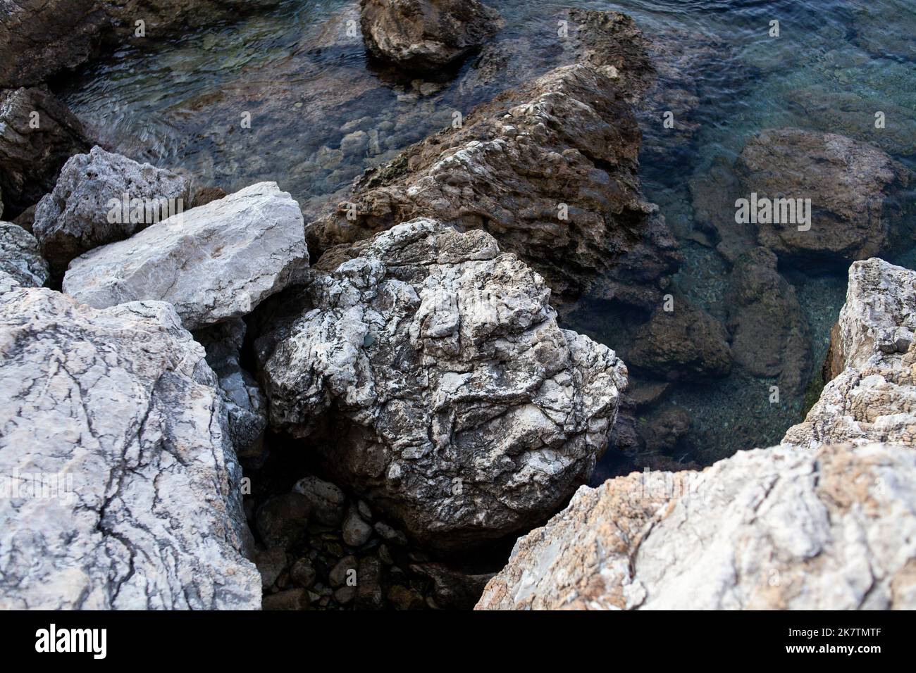 Sea Surface Rocks Rocks and stones in the sea. Sea stones. Rough stone surface texture ...