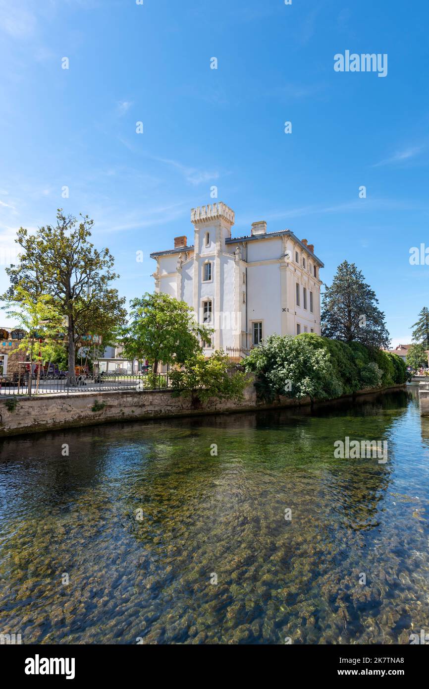 Ancient building at L'Isle-sur-la-Sorgue with water canal in summer and with copy space. France Stock Photo