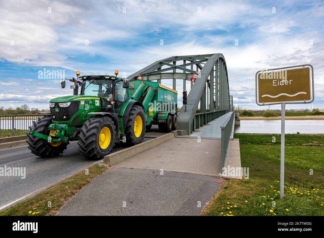 Tractor crosses the Eiderbrücke Friedrichstadt, double arch bridge from