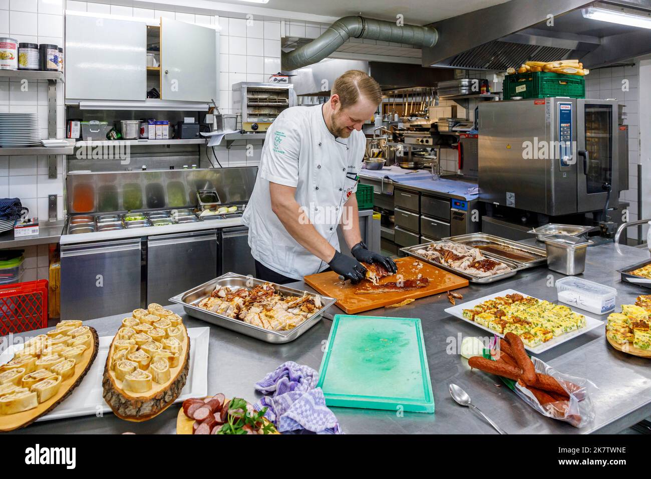 Chef preparing food in a professional kitchen Stock Photo - Alamy