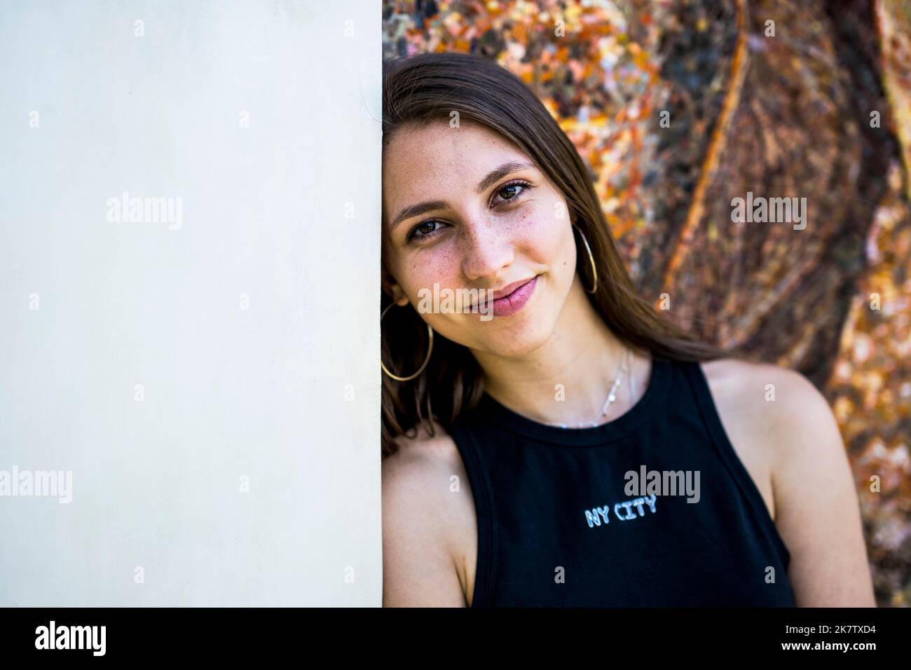 Portrait of an Athletic Young Woman Against a Background with Warm Tones Stock Photo