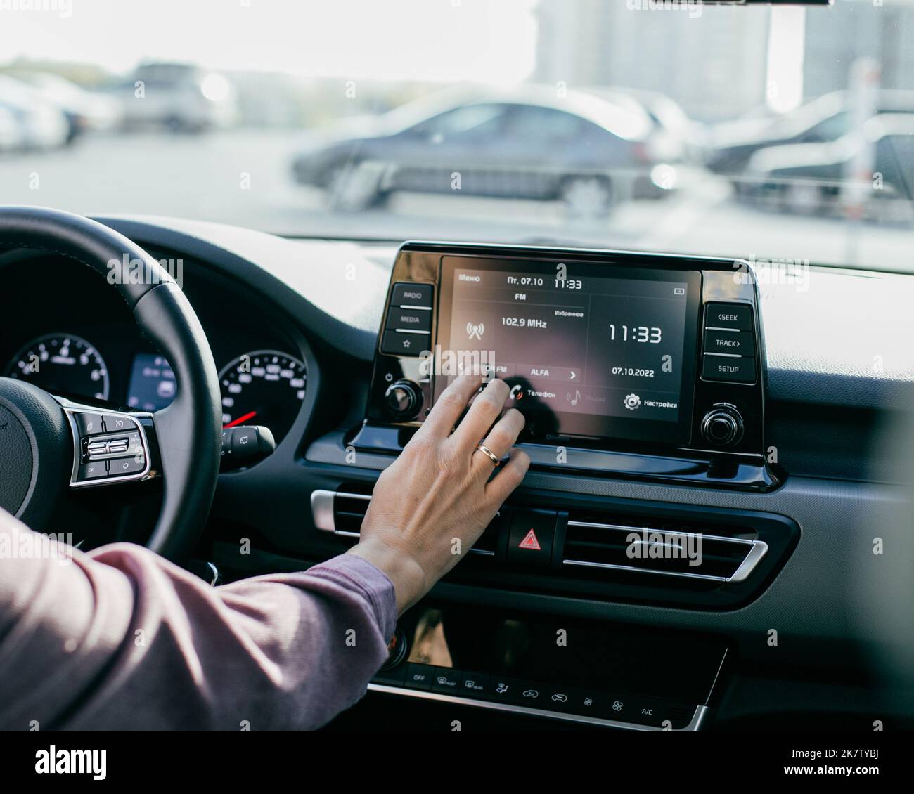 Car dashboard. Radio closeup. Woman sets up radio Stock Photo Alamy