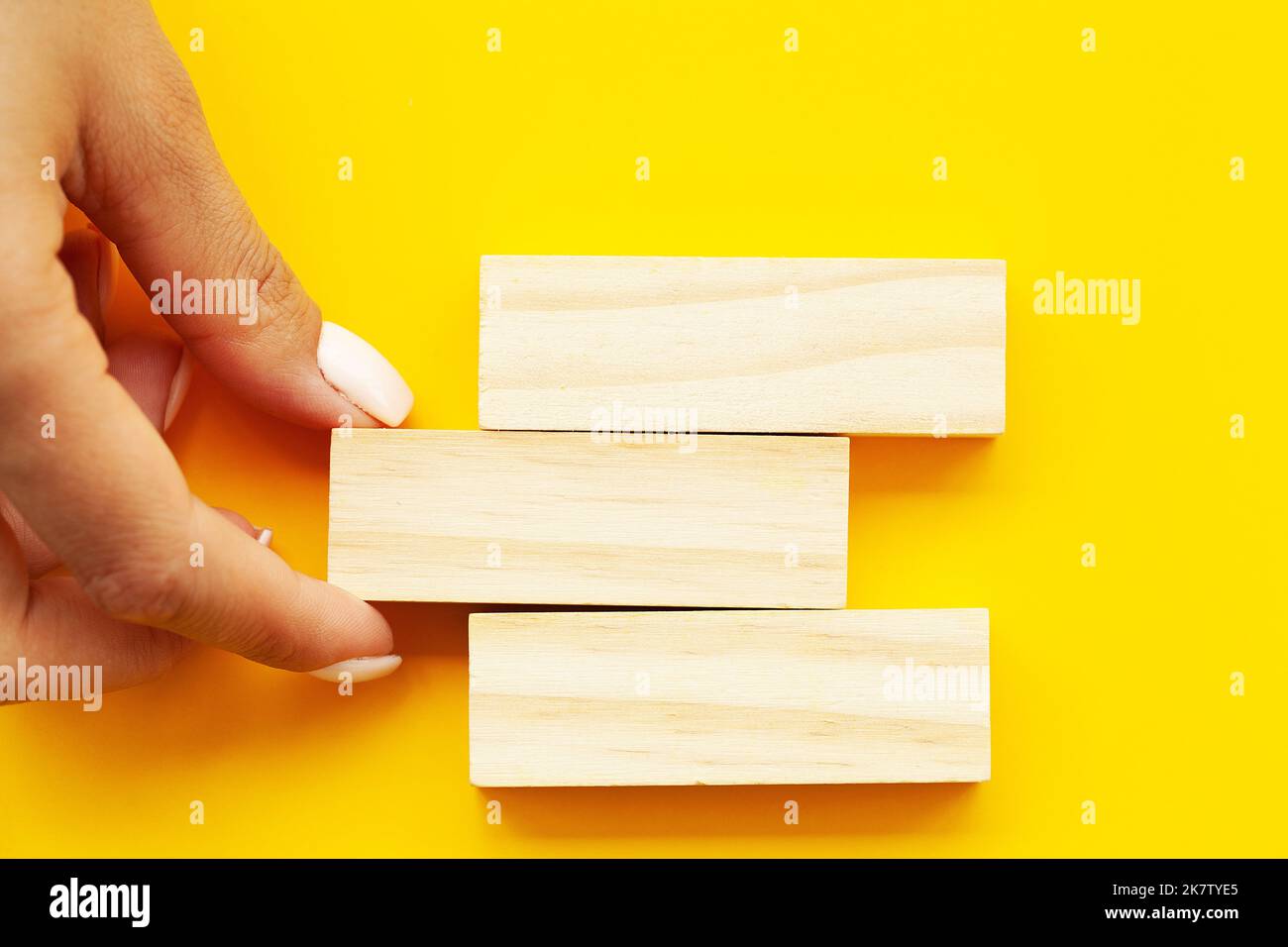 Woman hand stacked wooden blocks with space for text Stock Photo - Alamy
