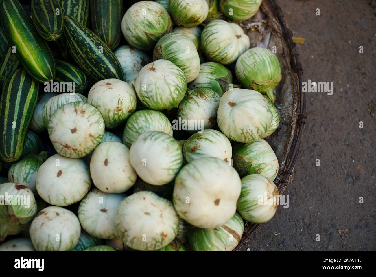 Basket of vegetables as eggplant, squash from Vietnamese vendor, popular Vietnam agriculture product Stock Photo