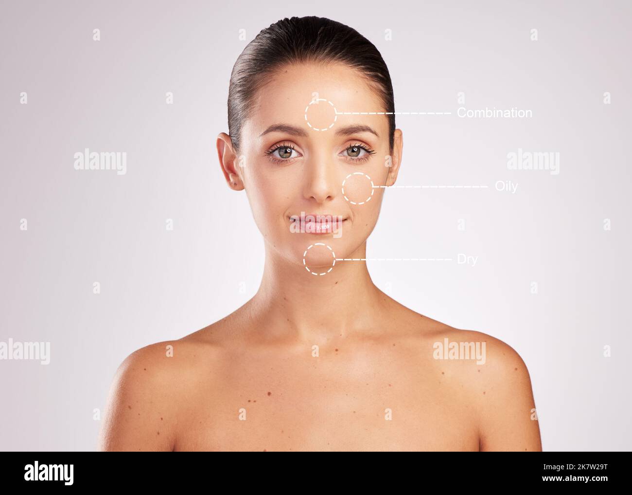 Whatever your skin type youre still beautiful. an attractive young woman with skin types indicated on her face against a studio background. Stock Photo