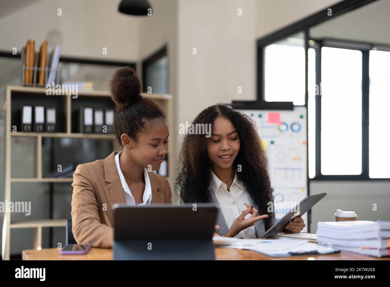 diverse coworkers working together in boardroom, brainstorming, discussing and analyzing and planning business strategy. Stock Photo