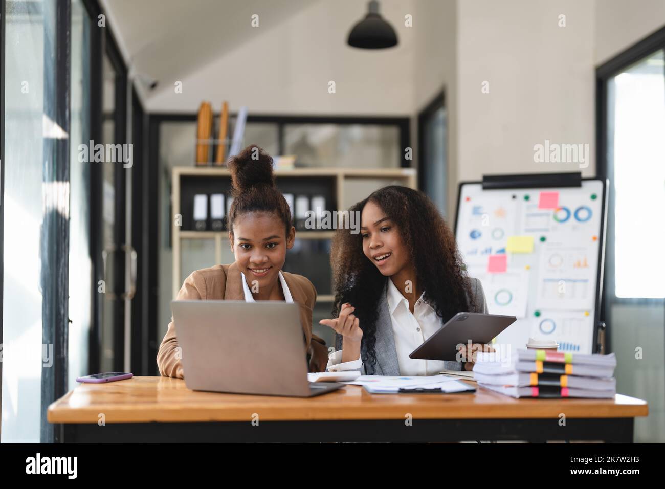 diverse coworkers working together in boardroom, brainstorming, discussing and analyzing and planning business strategy. Stock Photo