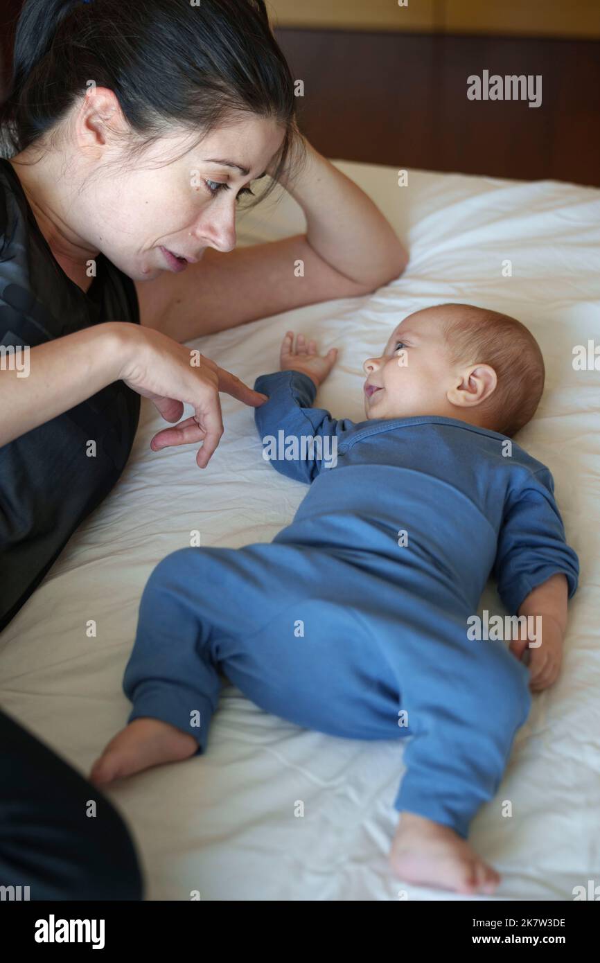 Baby bonding with his mother Stock Photo