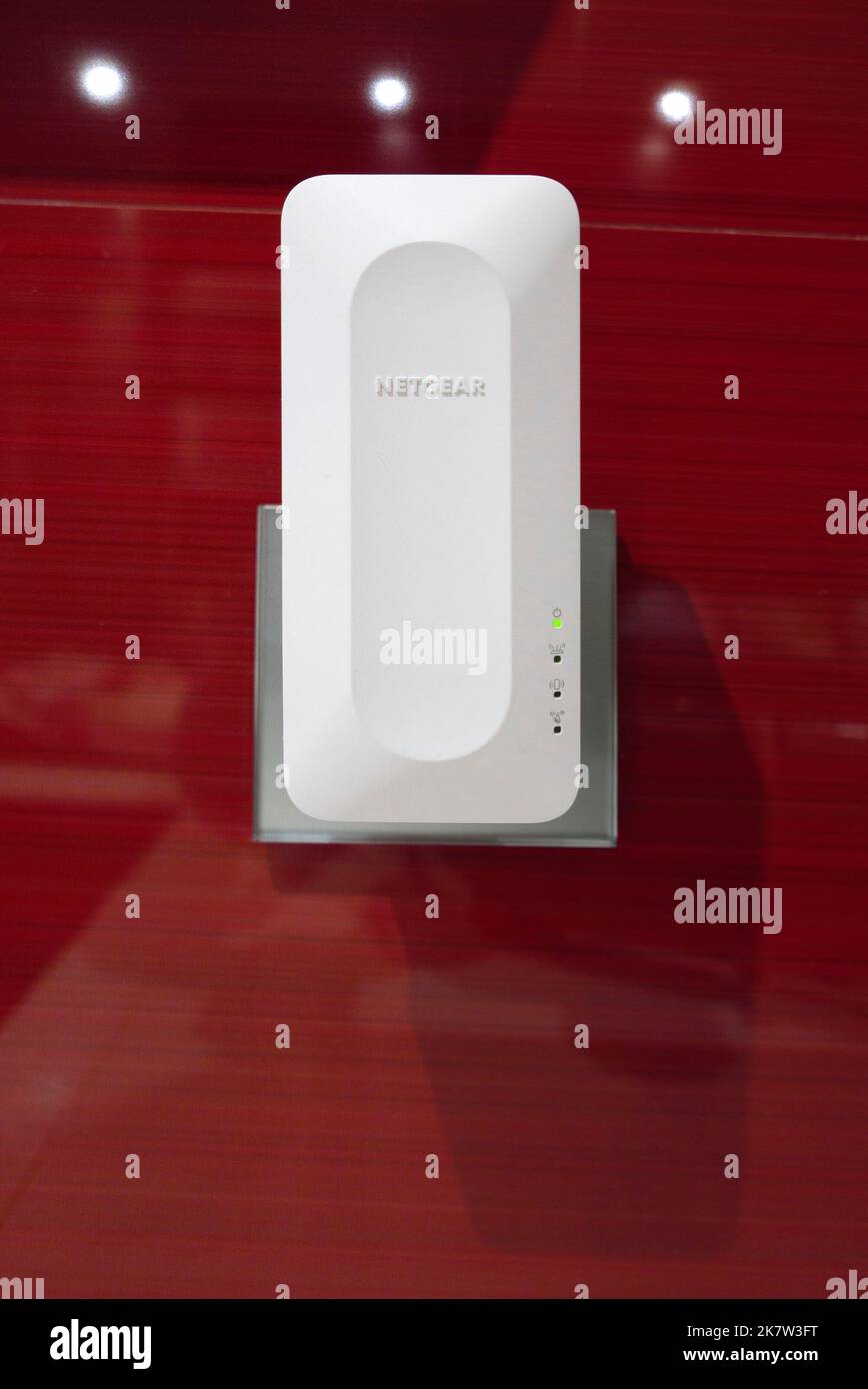 Netgear WiFi 6 mesh extender plugged into a wall socket at home Stock