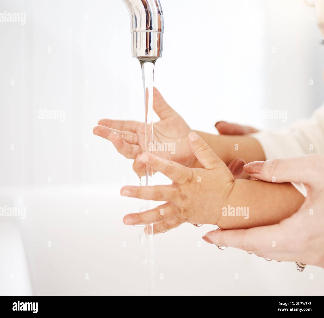 Everyone should wash their hands regularly. a woman washing her babys