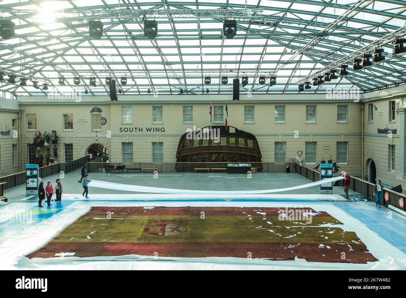 London UK 19 October 2022 Greenwich maritime Museum, Rare opportunity to see   10m x 14.5m woolen flag, showing damage suffered at the battle of Trafalgar. The flag will be displayed this  week leading up to Trafalgar Day on the National Maritime Museum’s Great Map (the only space vast enough to fully display the Spanish ensign), with visitors able to walk alongside the flag or view its full scale from the upper balcony. Paul Quezada-Neiman/Alamy Live News Stock Photo