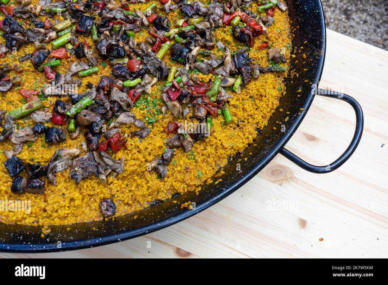 Vegetarian paella cooking over a fire at a food festival in Estoril