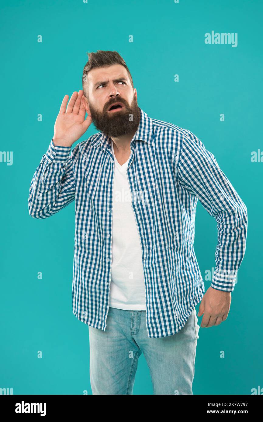Bearded man concentrated on listening. Hearing problems. What