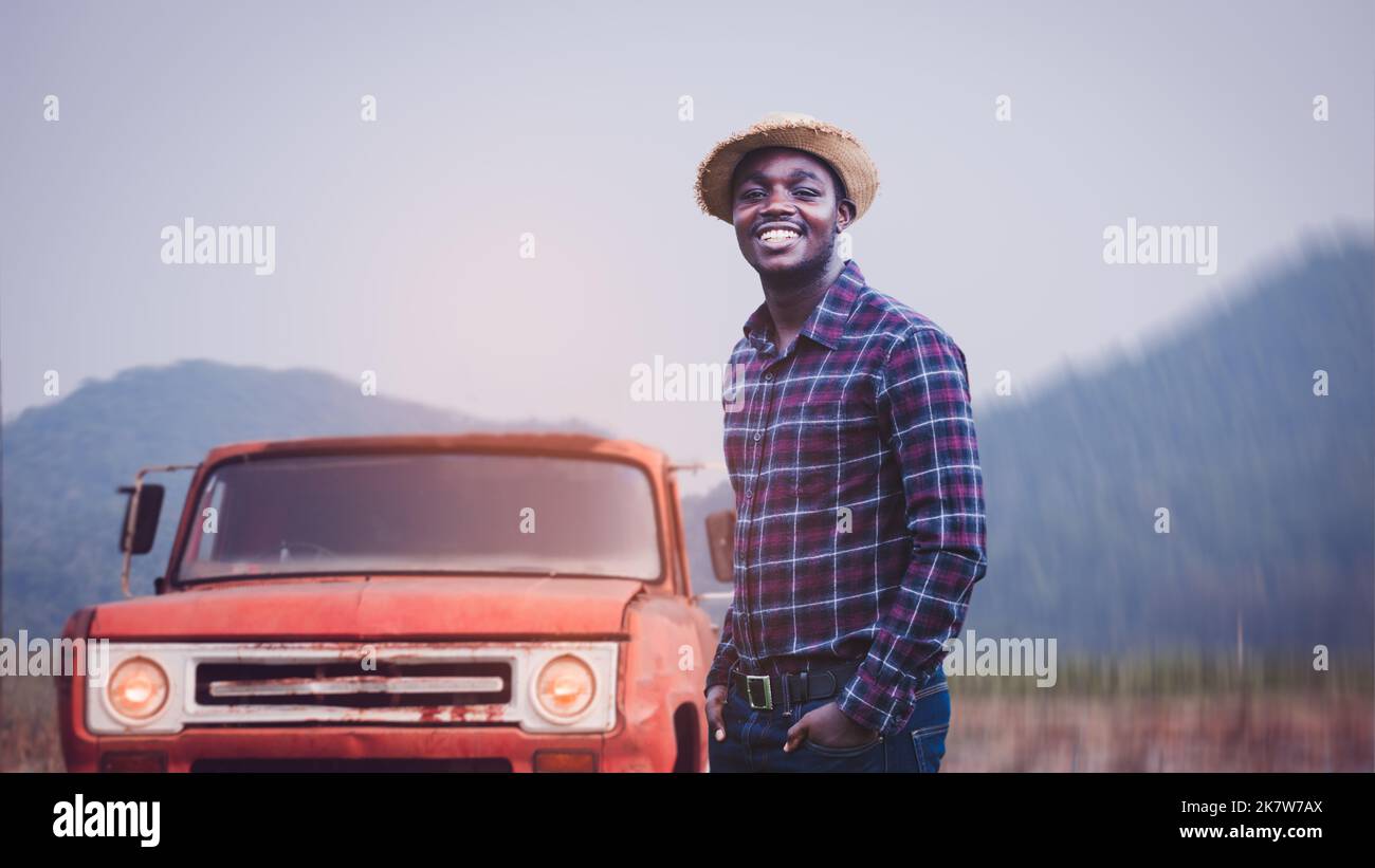 Success african male farmer in checkered shirt and straw hat looking ...