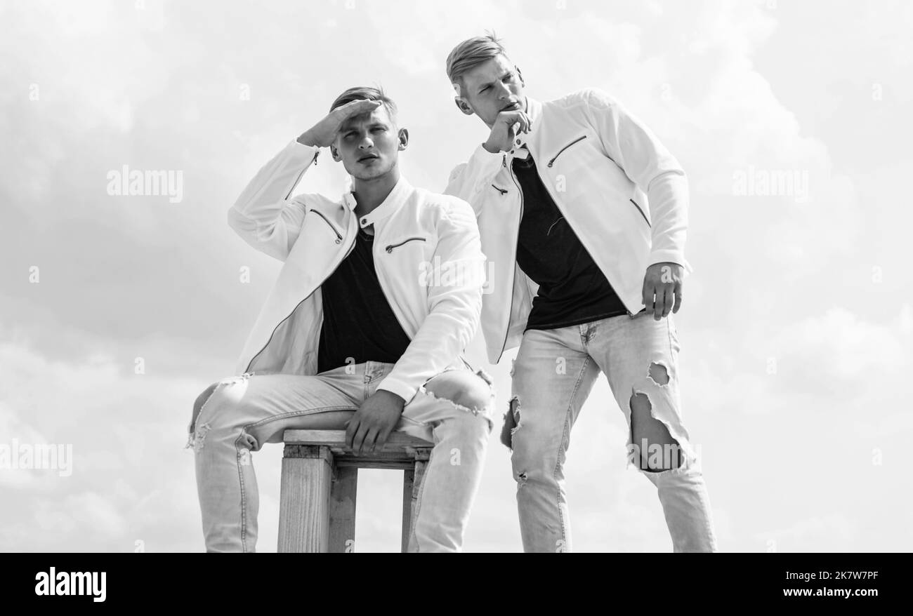 twin brothers men in white casual clothes look alike, identically Stock