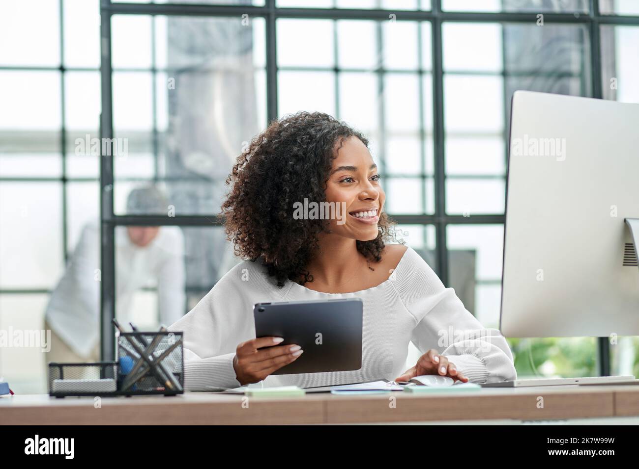 successful businesswoman using a digital tablet and computer . Stock Photo