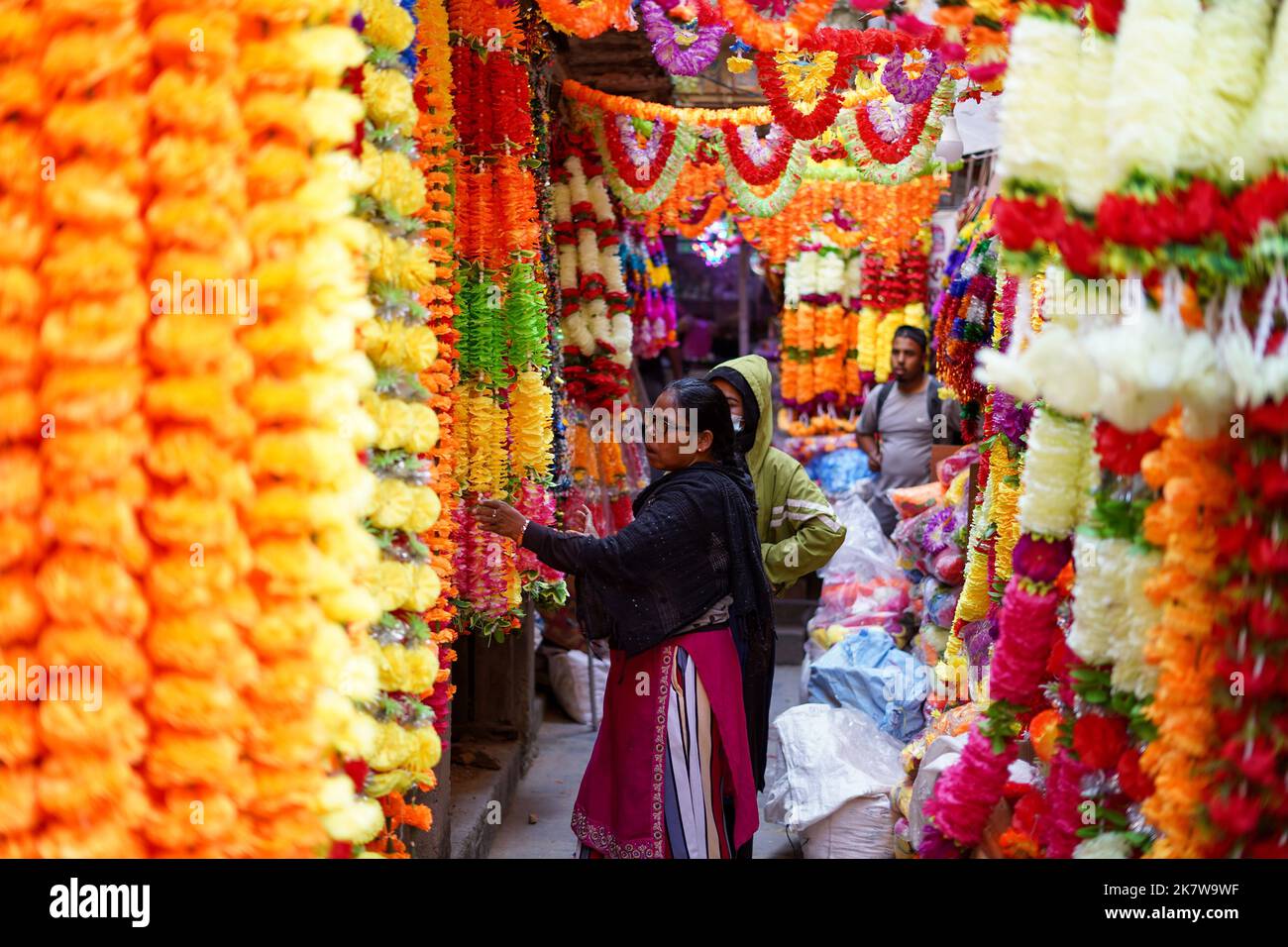 Kathmandu, NE, Nepal. 19th Oct, 2022. A woman checks plastic garlands