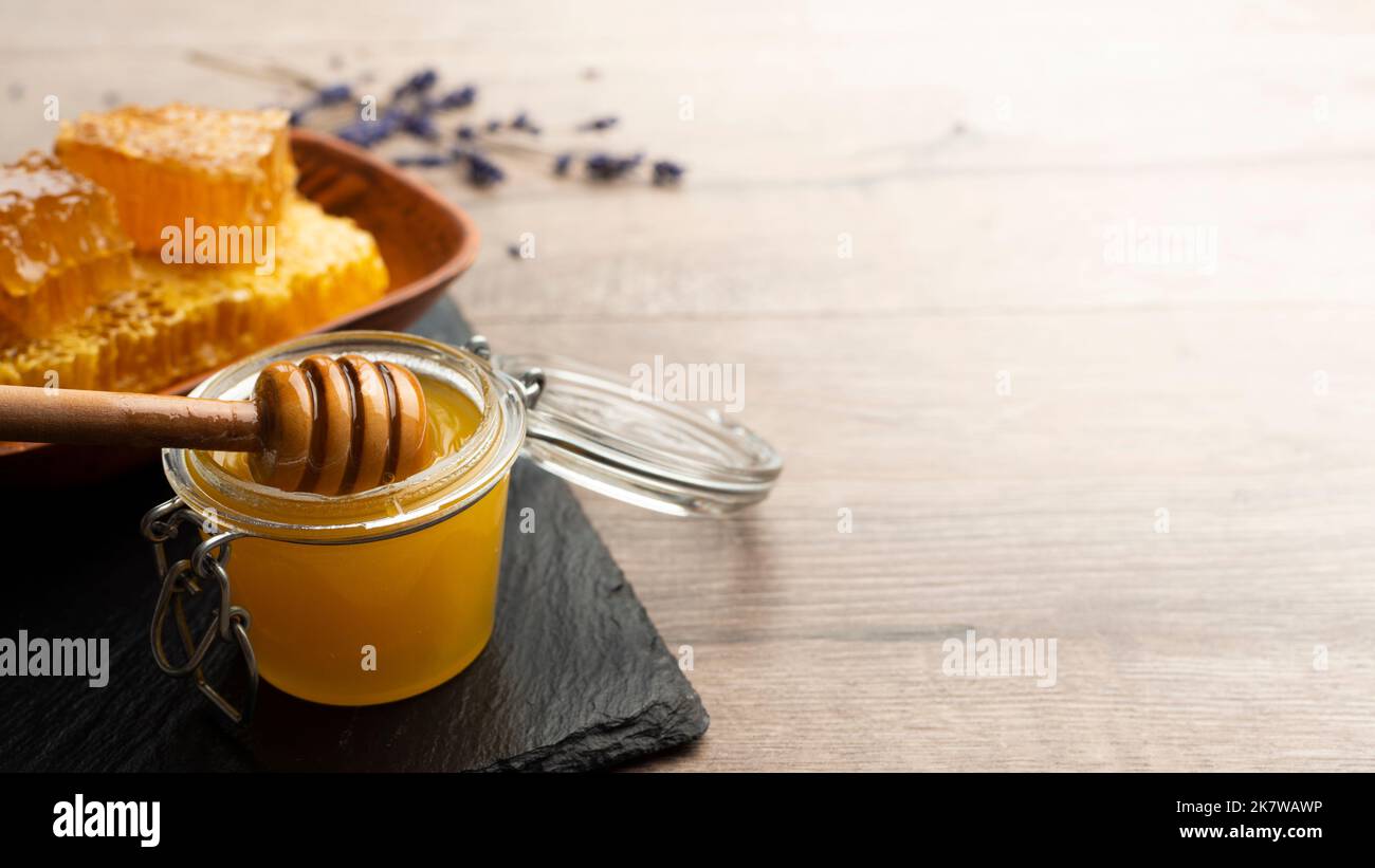 Honey on wooden honey-dipper closeup food background with copy-space Stock Photo