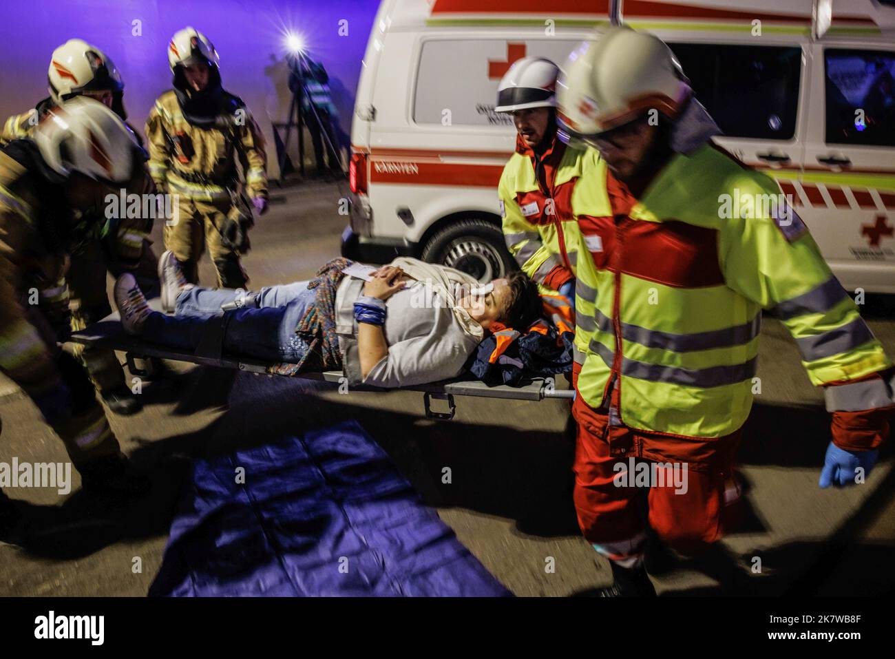 Austrian firemen and medical personnel carry an accident casualty away ...