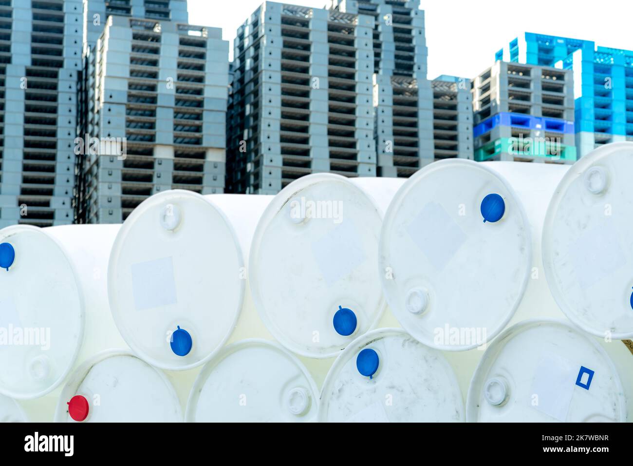 Old chemical barrels. Empty white chemical drums stack on blur