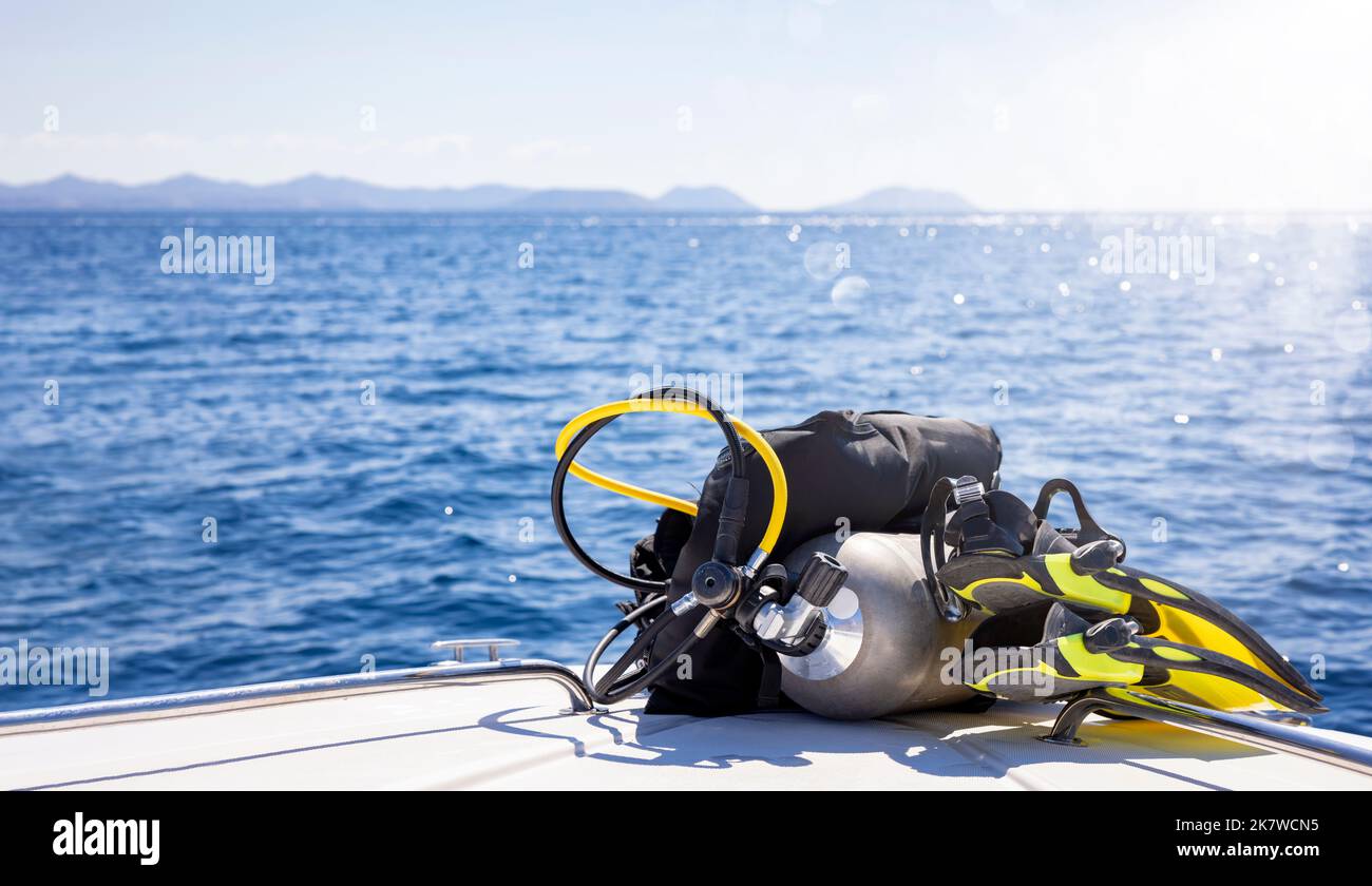 Concept of scuba diving with tank and equipment lying on a boat Stock Photo