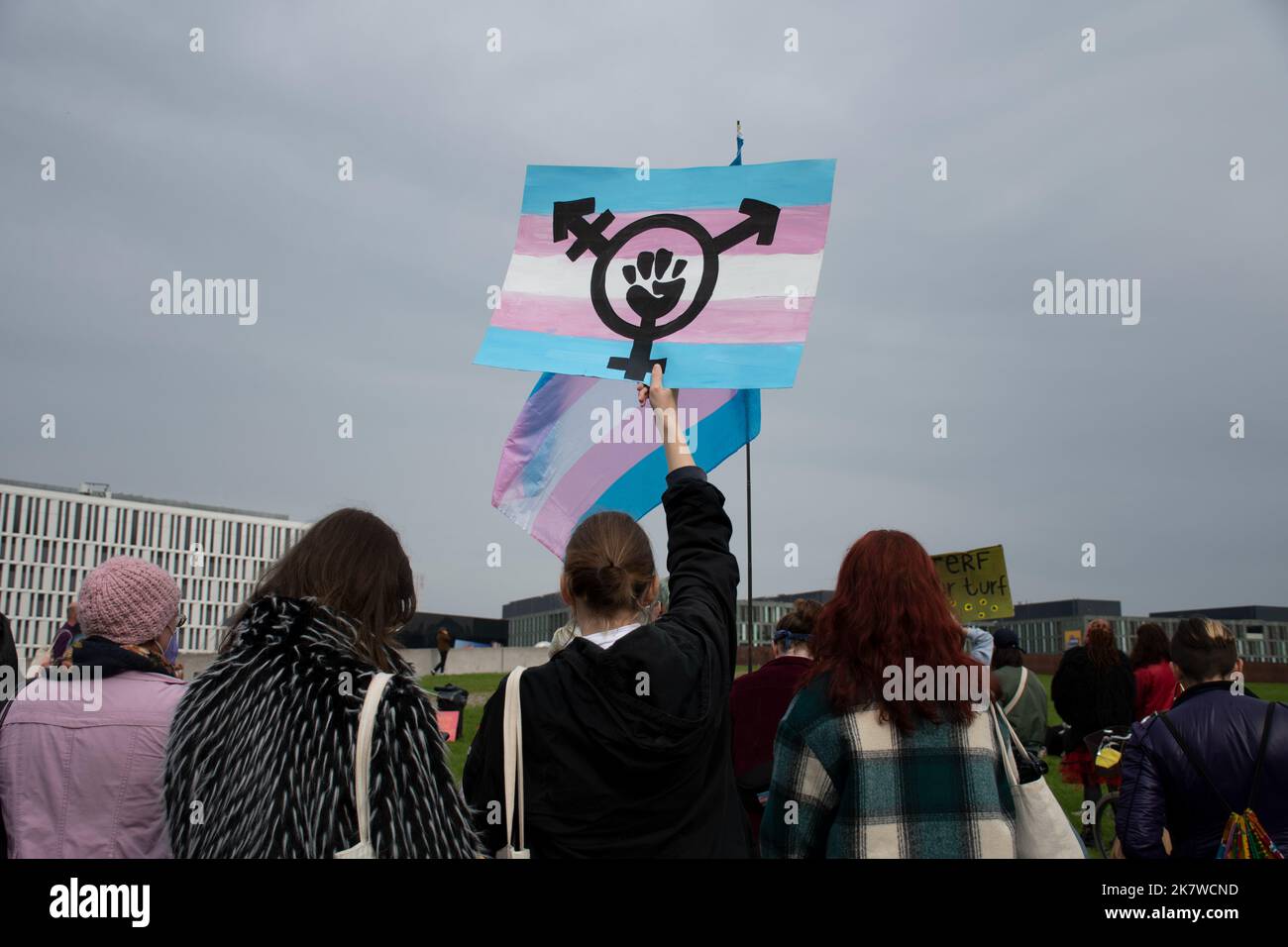 A Transgender rights protester holds up a sign at a demonstration against Terfs in Berlin, Germany Stock Photo