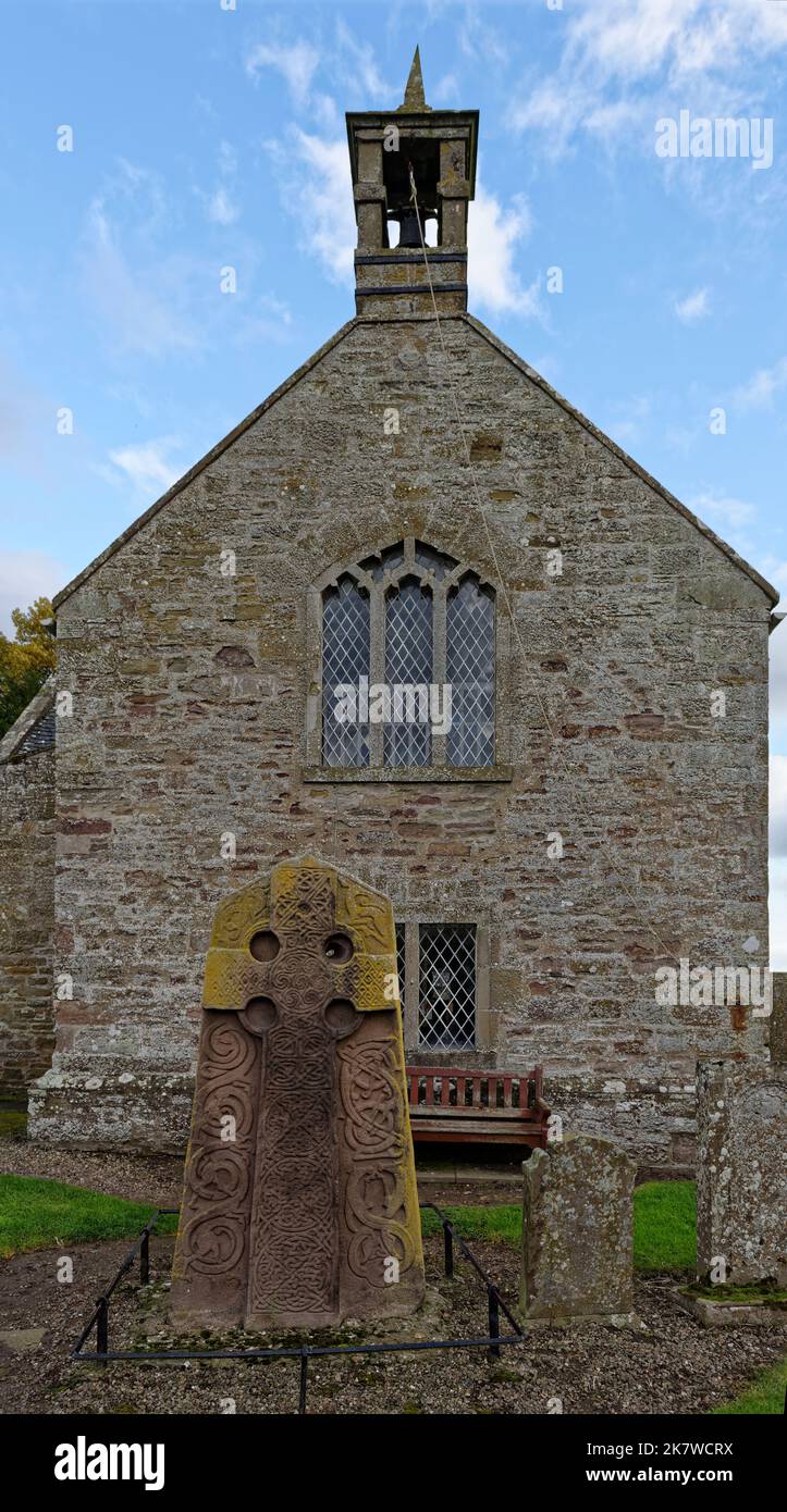 The West View of the Aberlemno 2 Sculptured Stone in the Kirkyard of the local church, with its Celtic Cross, beneath the Bell Tower. Stock Photo