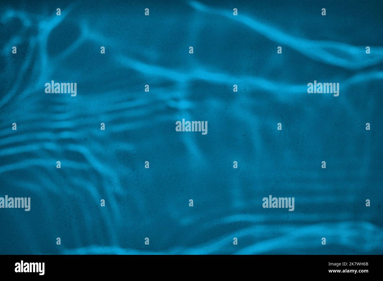 Shadow and light water caustic effect on blue concrete wall Stock Photo