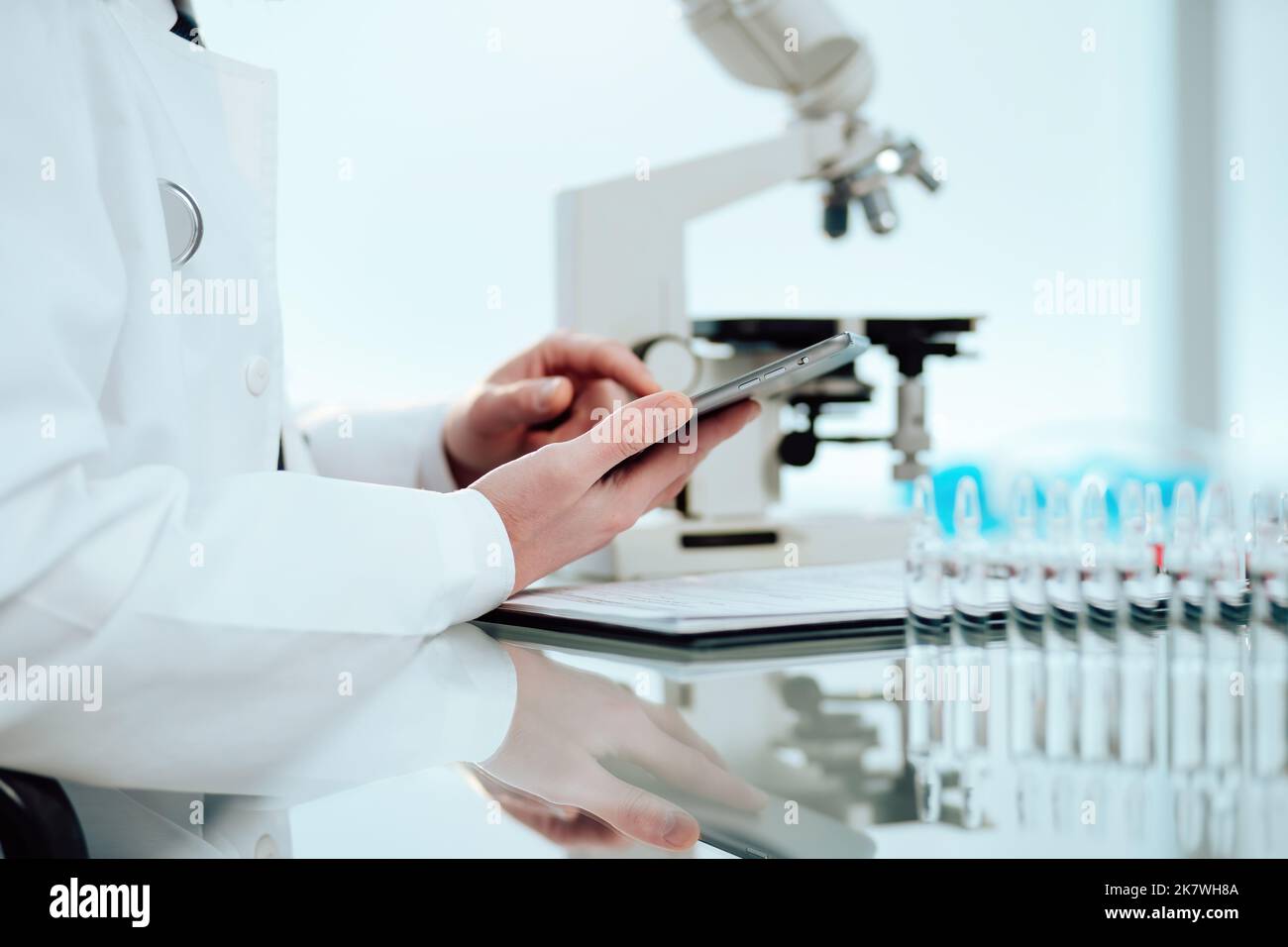 scientist using a digital tablet while working in the lab. Stock Photo