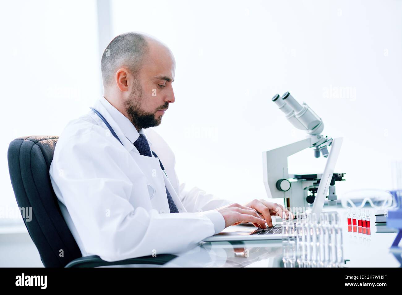 scientist using a laptop in a medical lab. Stock Photo
