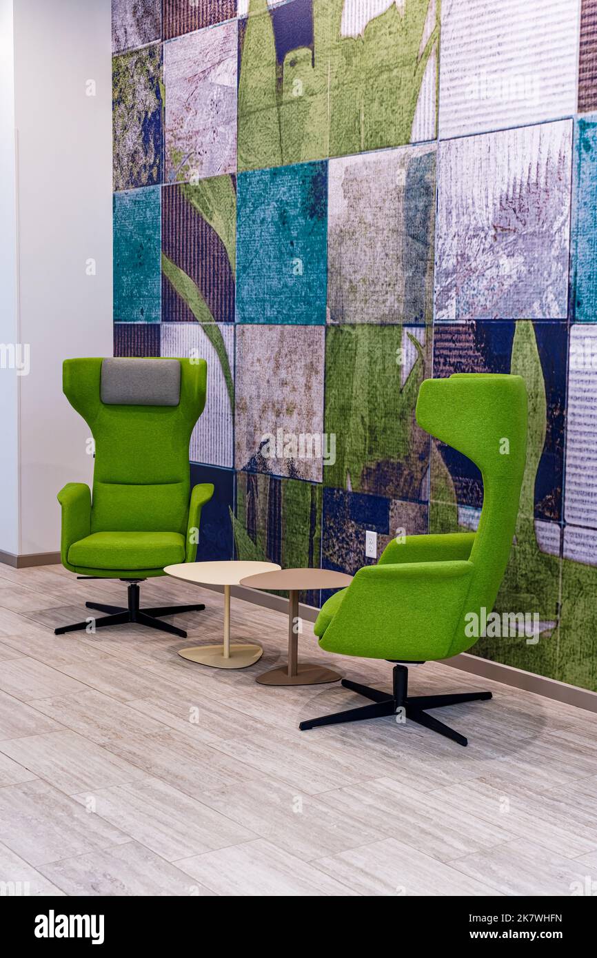 hotel lobby conversation area with green modern style chairs Stock Photo